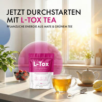 Thumbnail for L-Tox Tea Beutel mit Teetasse, Teekanne, Beeren und Zitrone auf heller Küchenarbeitsfläche